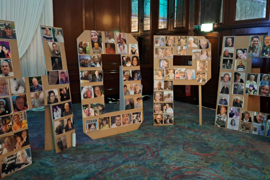 A collage board in the shape of the word 'HOPE'. The collage features photos of individuals and groups.