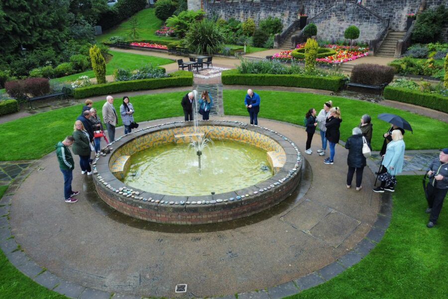 A group of people gathered around a fountain.