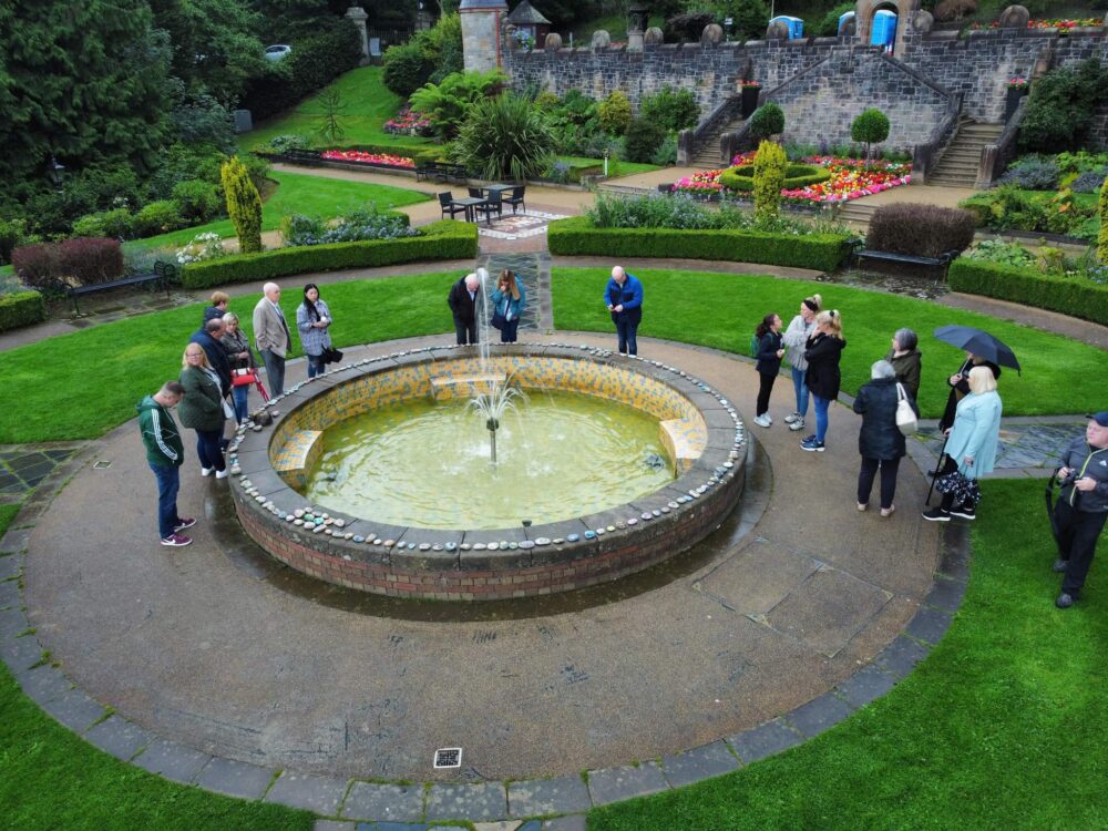People gather around a fountain.